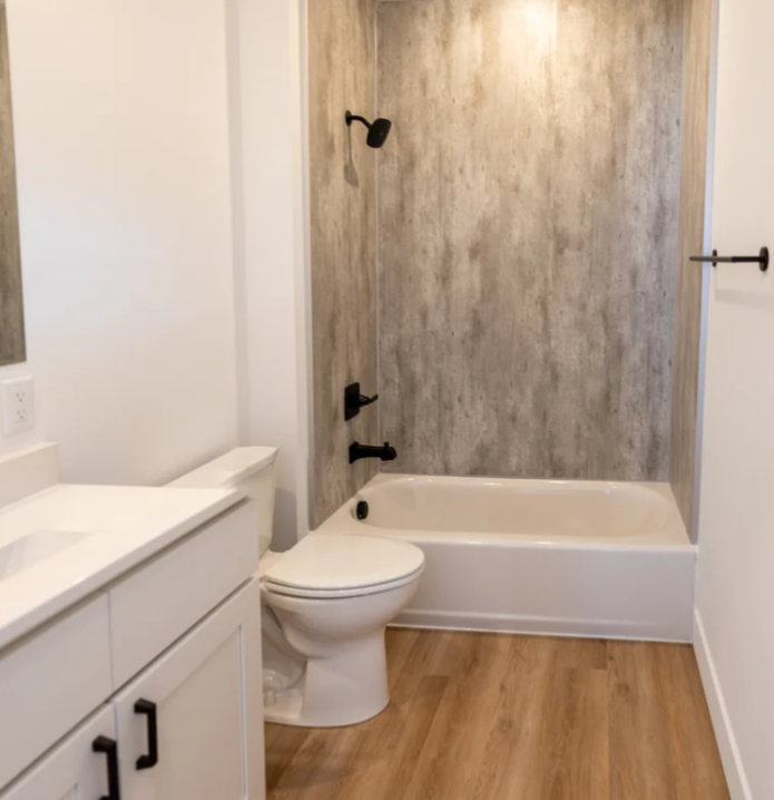 rendering of a bathroom with sink, toilet, tub and shower